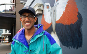 Kiran Parbhu in front of one of his murals