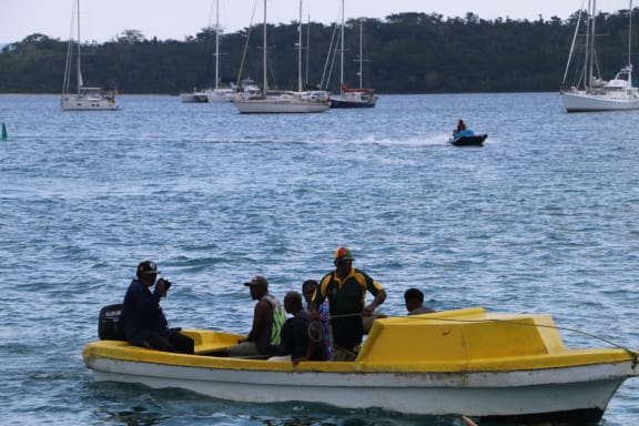 Port Vila generic - people at the seafront on a punt