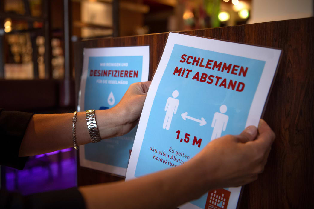 Stickers with hygiene regulations are hung up in a restaurant in Bremen, Germany, on 18 May, 2020.