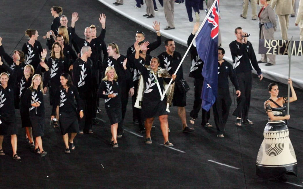Flag-bearer Beatrice Faumuina wearing a Maori cloak leads the New Zealand team at the Athens Games in 2004