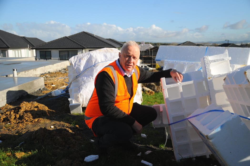 Auckland senior waste planning advisor Mark Roberts next to a pile of polystyrene insulation left on a vacant section in Flatbush. He said it could easily blow away in the wind and the beads could end up in the waterways.