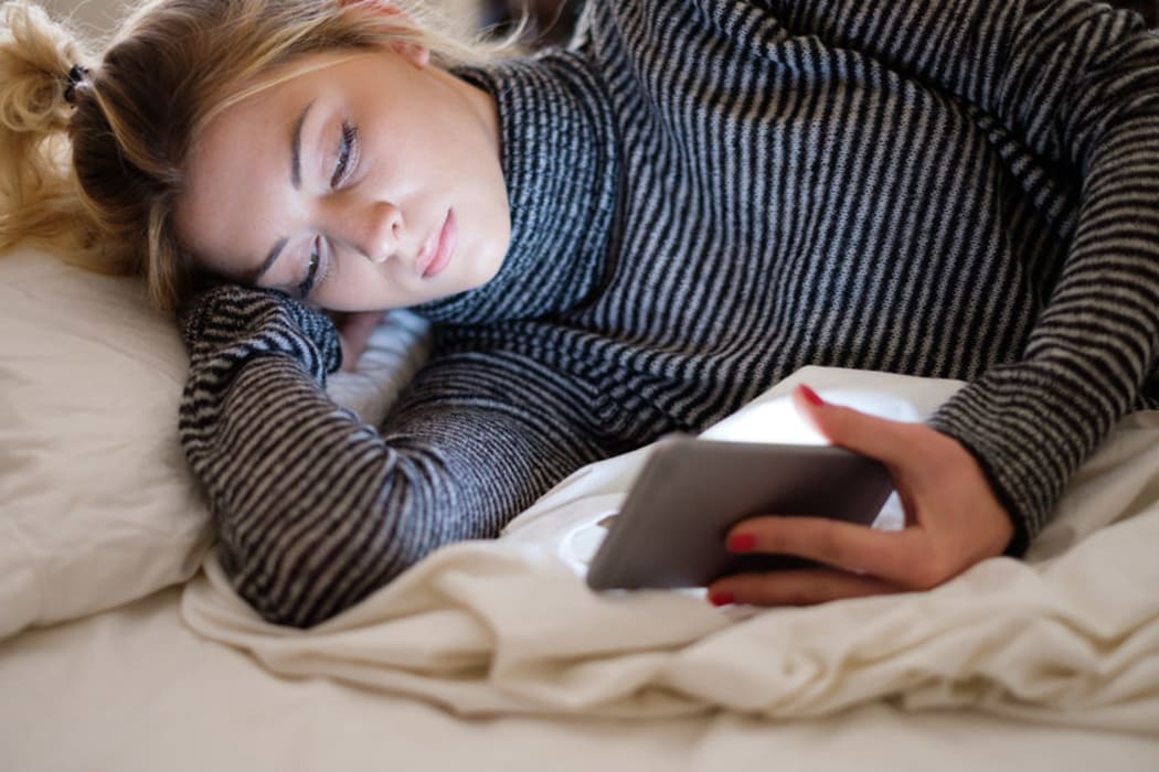 89247445 - teenage girl victim of bullying reading text message