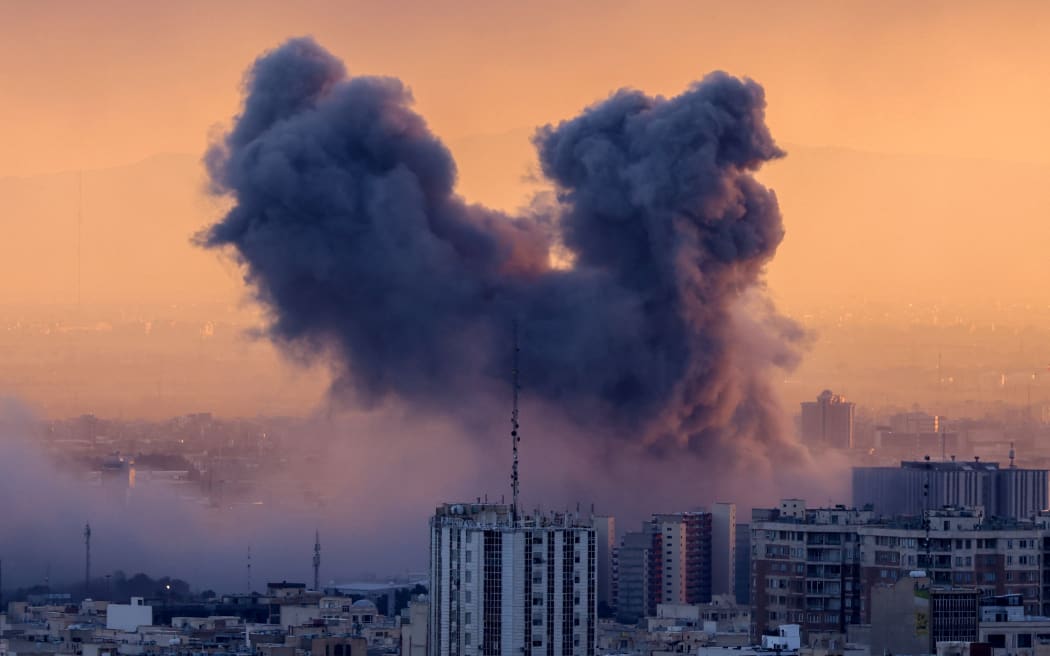 A plume of smoke rises after a strike on the Iranian capital Tehran, on March 3, 2026. Iran stepped up its attacks on economic targets and US missions across the Middle East on Tuesday as the US president warned it was "too late" for the Islamic republic to seek talks to escape the war.  The United States and Israel launched strikes against Iran on February 28, with the killing of Iran's supreme leader and the Islamic republic retaliated with barrages of missiles at Gulf states and Israel. (Photo by ATTA KENARE / AFP)