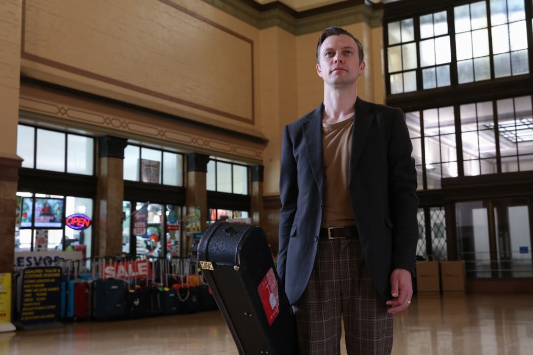 Anthony Tonnon waiting for the train on his Rail Lands tour
