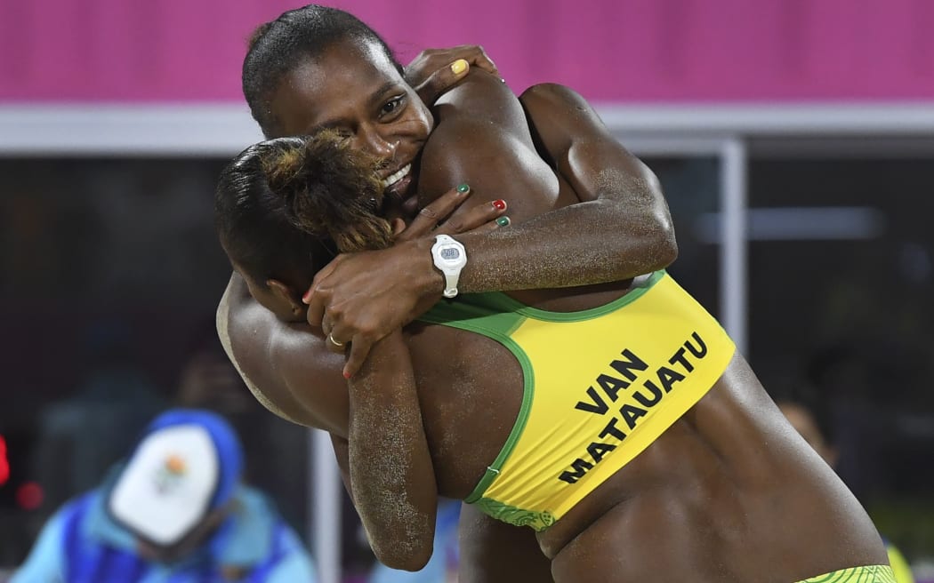 Vanuatu's Miller Pata and Linline Matauatu celebrate winning in the women's beach volleyball bronze medal match against Cyprus