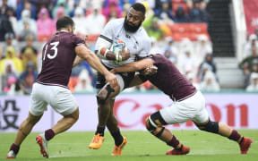 Fiji's centre Waisea Nayacalevu (C) is tackled by Georgians Davit Kacharava and Merab Sharikadze.
