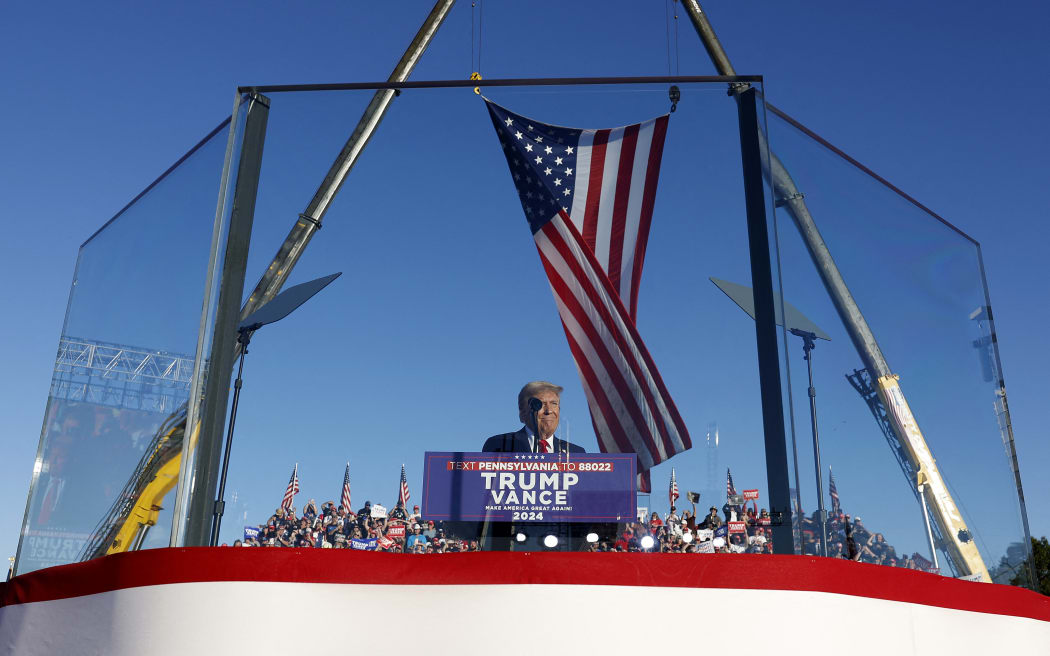BUTLER, PENNSYLVANIA - OCTOBER 05: Republican presidential nominee, former President Donald Trump addresses a campaign rally from behind bullet resistant glass at the Butler Farm Show fairgrounds on October 05, 2024 in Butler, Pennsylvania. This is the first time that Trump has returned to Butler since he was injured during an attempted assassination on July 13.   Anna Moneymaker/Getty Images/AFP (Photo by Anna Moneymaker / GETTY IMAGES NORTH AMERICA / Getty Images via AFP)