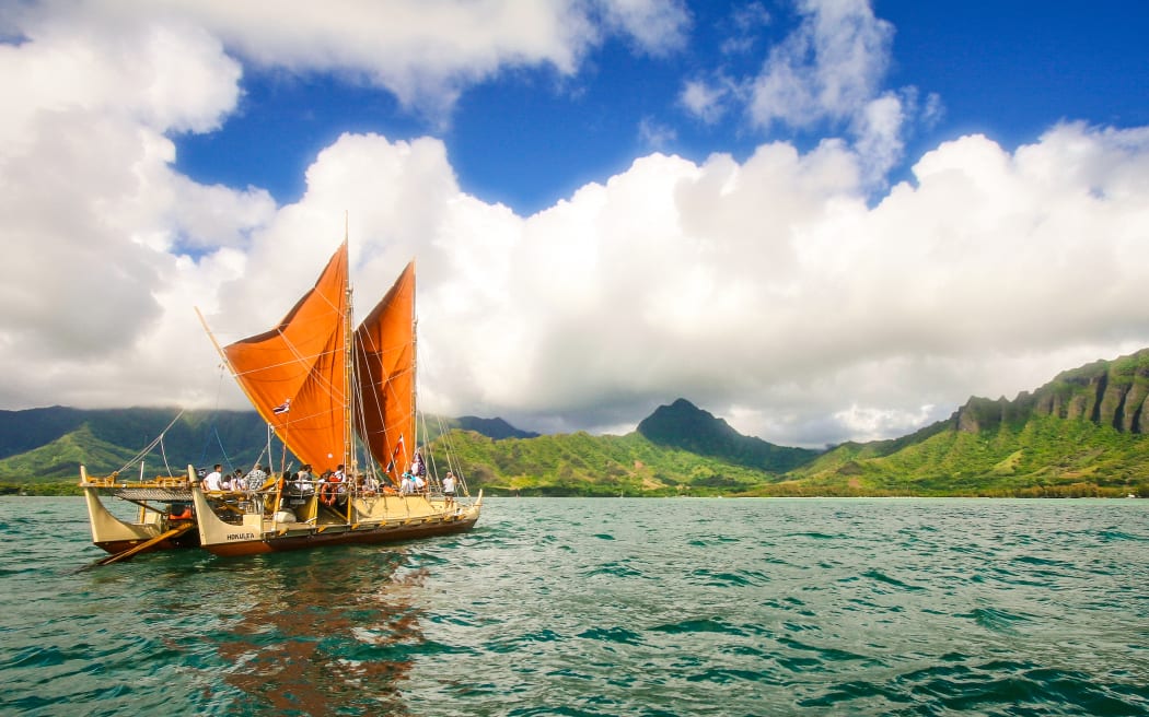 The day breaks over HÅkÅ«leÊ»a with Kualoa behind her.