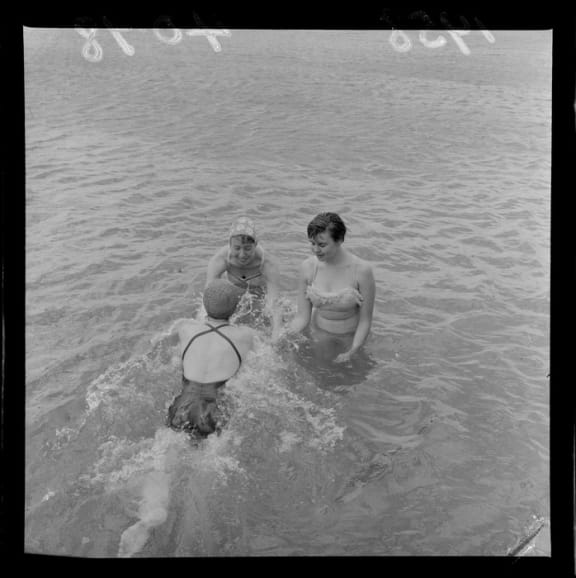 Three unidentified women swimming at Evans Bay, Wellington. Evening post (Newspaper. 1865-2002)