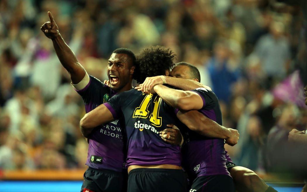 Suliasi Vunivalu (L) celebrates the try of Felise Kaufusi during the NRL Grand Final.