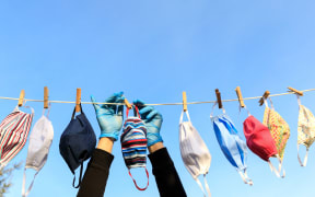 Drying mask hanging under the sun after use for disinfecting. Hygienic mask hanging on the rack outdoor after being washed for cleanness and hygiene during Covid-19 virus outbreak