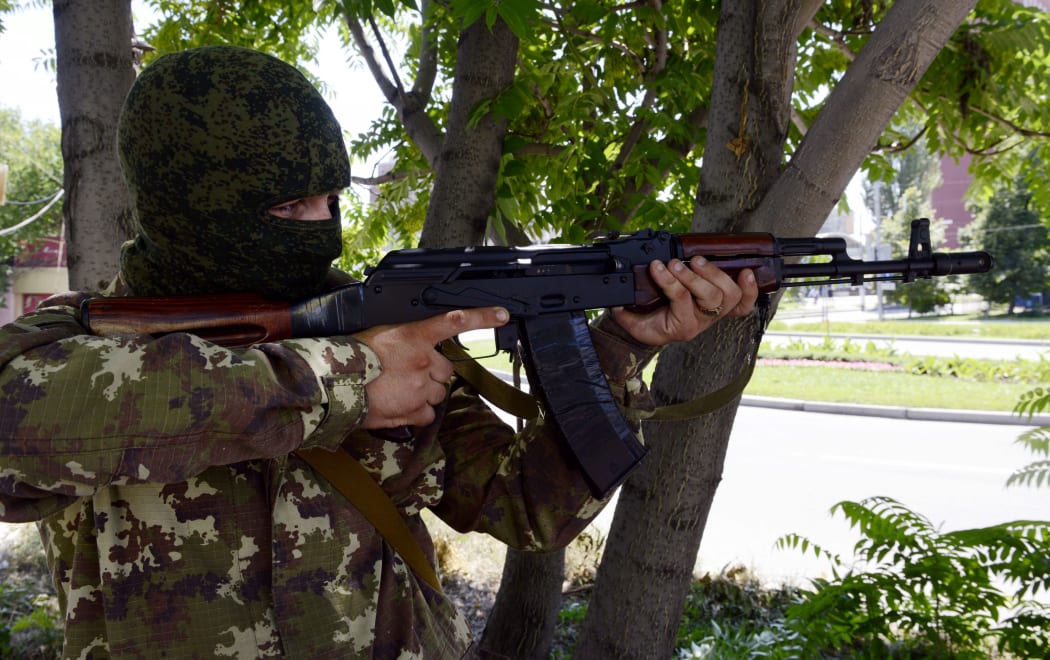 A pro-Russian militant aims a Kalashnikov during the combat with Ukrainian forces in the eastern Ukrainian city of Donetsk on July 21, 2014.