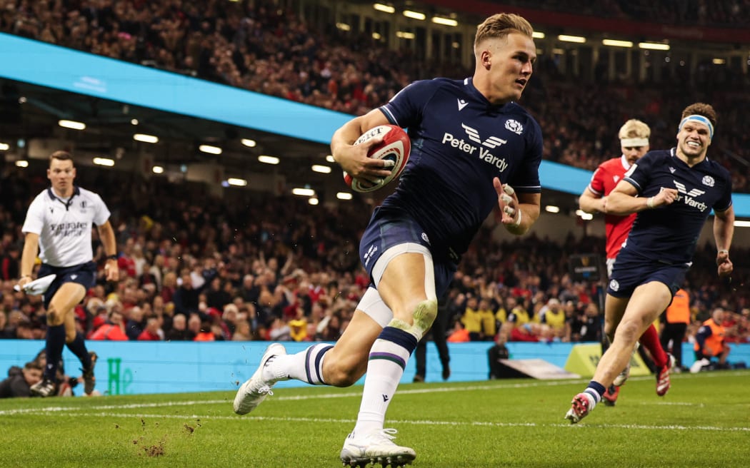 Scotland's wing Duhan van der Merwe (C) runs with the ball to score a try during the Six Nations international rugby union match between Wales and Scotland at the Principality Stadium in Cardiff, south Wales, on February 3, 2024. (Photo by Adrian DENNIS / AFP) / RESTRICTED TO EDITORIAL USE. Use in books subject to Welsh Rugby Union (WRU) approval.
