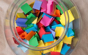Stock photo, notelets in a jar - to 'draw a name from the hat'
