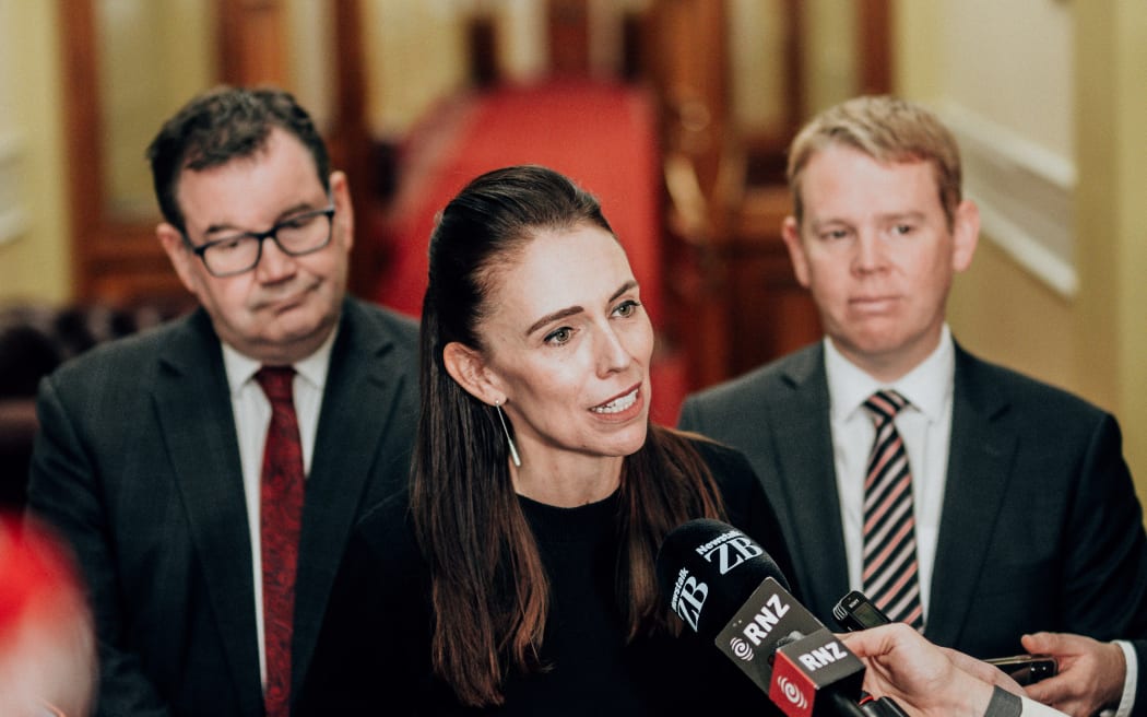 Jacinda Ardern flanked by Grant Robertson, left, and Chris Hipkins, right.