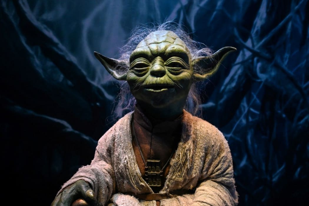 A life-size figurine of Yoda from the Star Wars series is displayed at the Star Wars Identities exhibition during a media preview at the ArtScience Museum in Singapore on January 28, 2021. (Photo by ROSLAN RAHMAN / AFP)