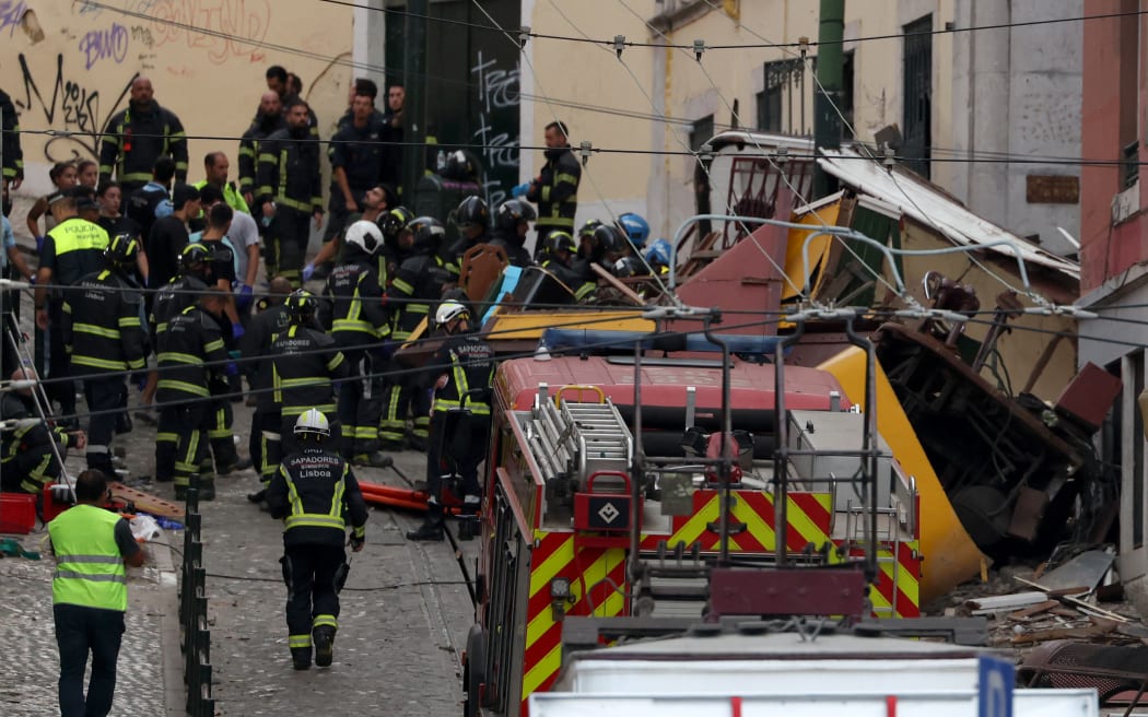Police and firefighters work on the site of a funicular railway accident in Lisbon, on September 3, 2025. The accident of a funicular railway caused several dead and seriously injured in Lisbon, announced the Portugal's President of the Republic. (Photo by PATRICIA DE MELO MOREIRA / AFP)