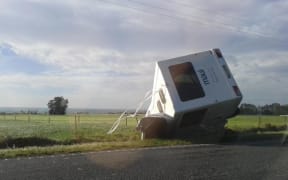 A campervan blew over in strong wind this morning on a road north of Kaikoura.