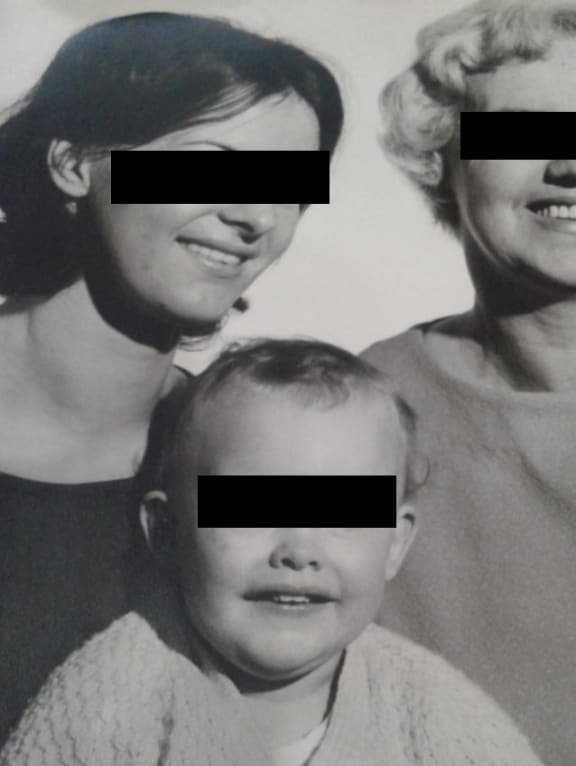 A portrait of "Carol" with her mother and son. Their faces are blacked out.