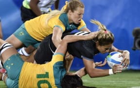 Kayla McAlister breaks through Australia's defence to score for New Zealand.