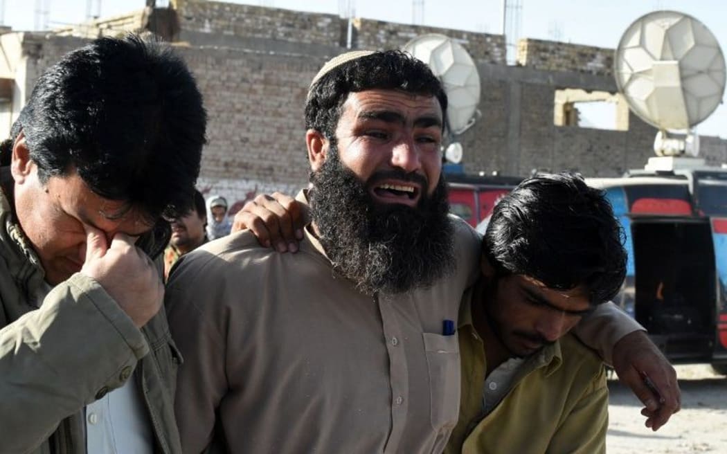 Pakistani relatives mourn the loss of family members after the attack in Quetta.