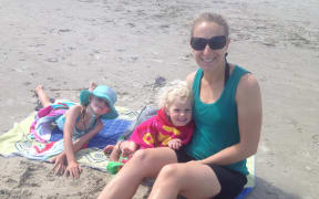 Sharlene Kelly and her daughters on a beach