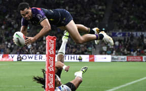 Xavier Coates of the Melbourne Storm scores a match-winning try against the Warriors.