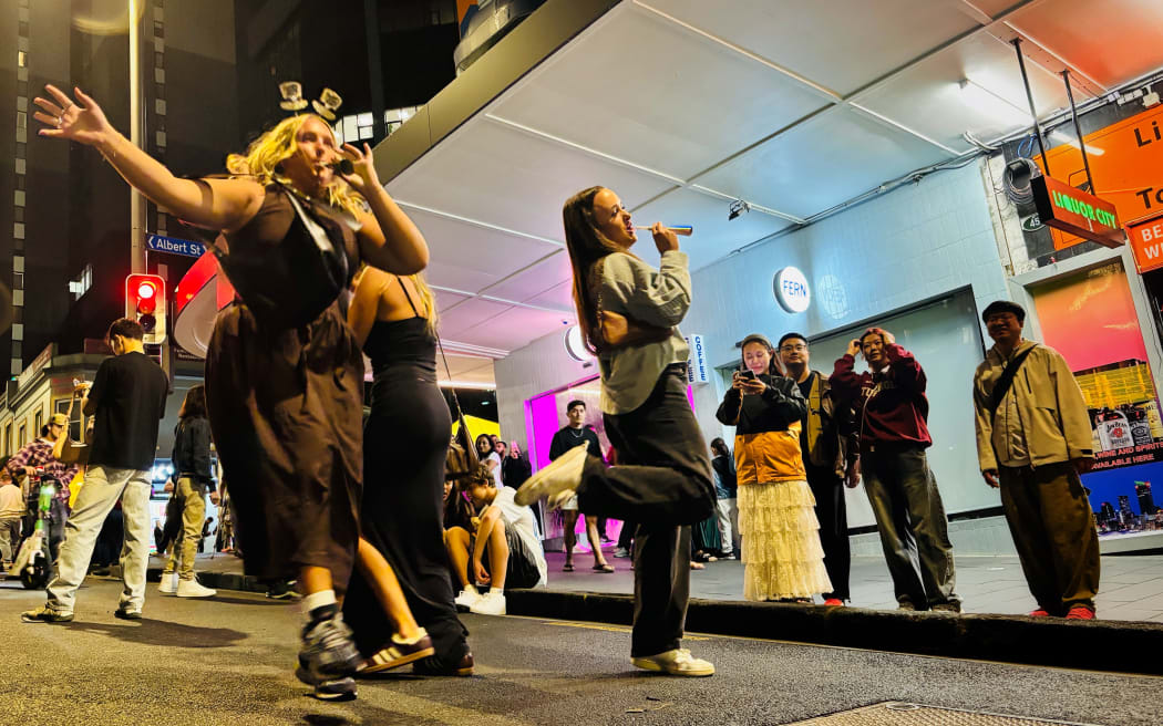 The group from Las Vegas  with their horns in the street.