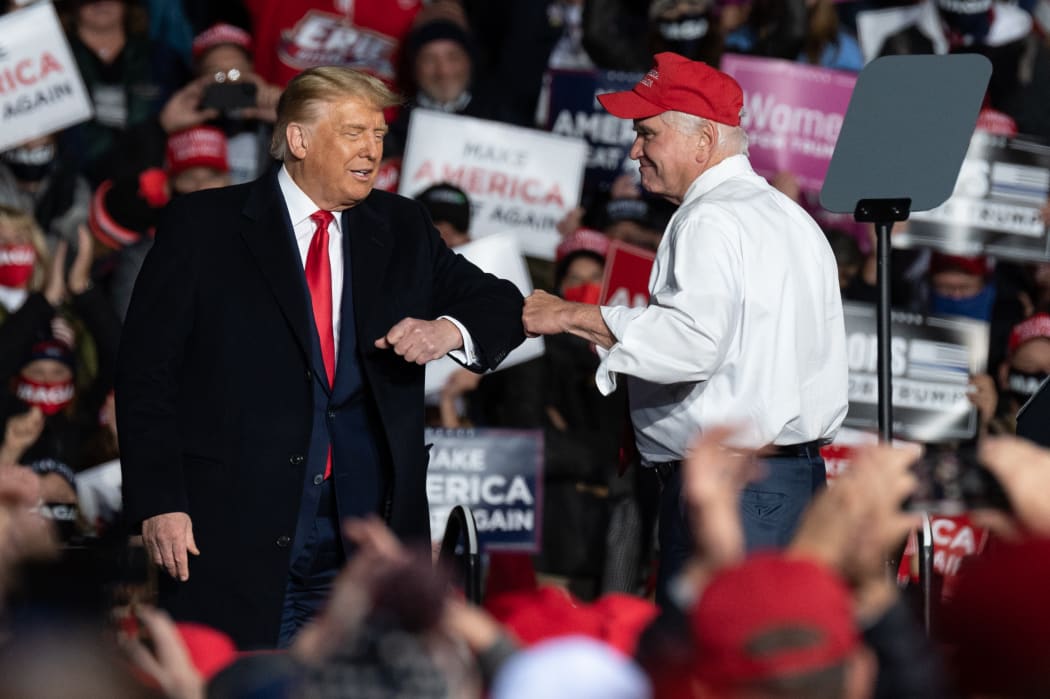 US congressman Mike Kelly bumps arms with President Donald Trump during a campaign rally at the Erie International Airport on Wednesday, 21 October, 2020, Pennsylvania.