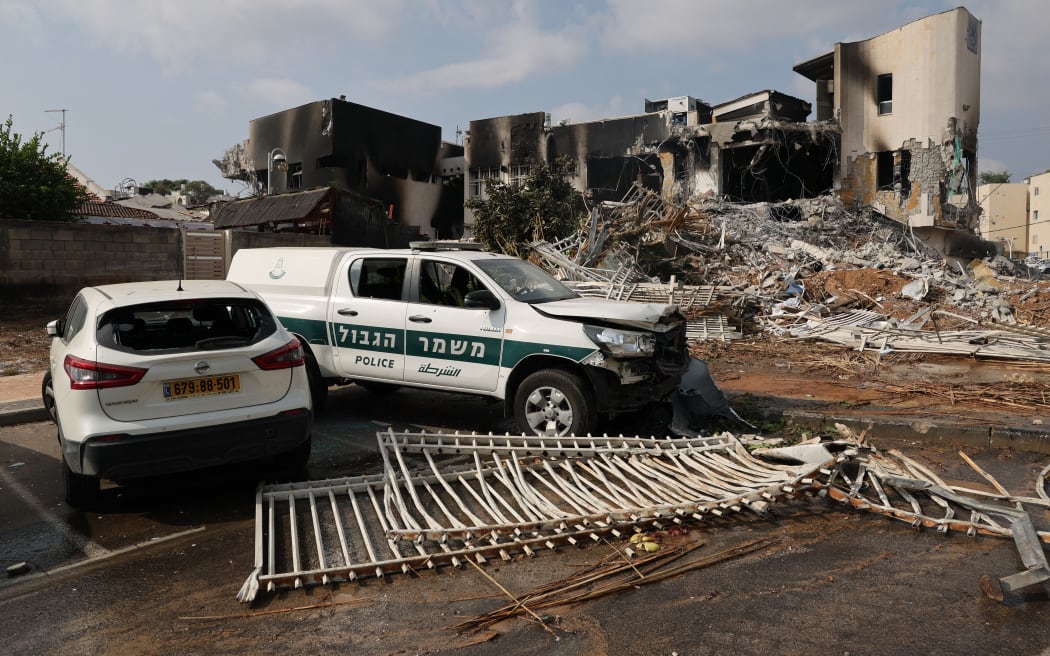 Cars are parked in front of an Israeli police station that was damaged during battles to dislodge Hamas militants who were stationed inside, on October 8, 2023. Israel's prime minister of October 8 warned of a "long and difficult" war, as fighting with Hamas left hundreds killed on both sides after a surprise attack on Israel by the Palestinian militant group. (Photo by JACK GUEZ / AFP)