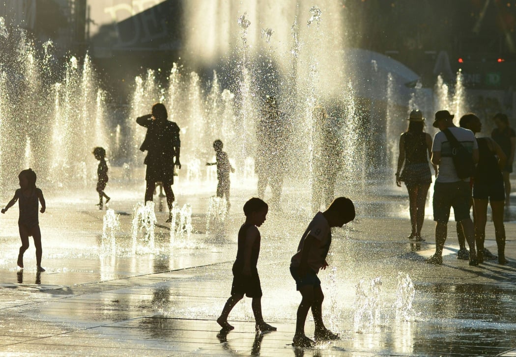 Montreal children cool off at a water fountain in the midst of a deadly heat wave.