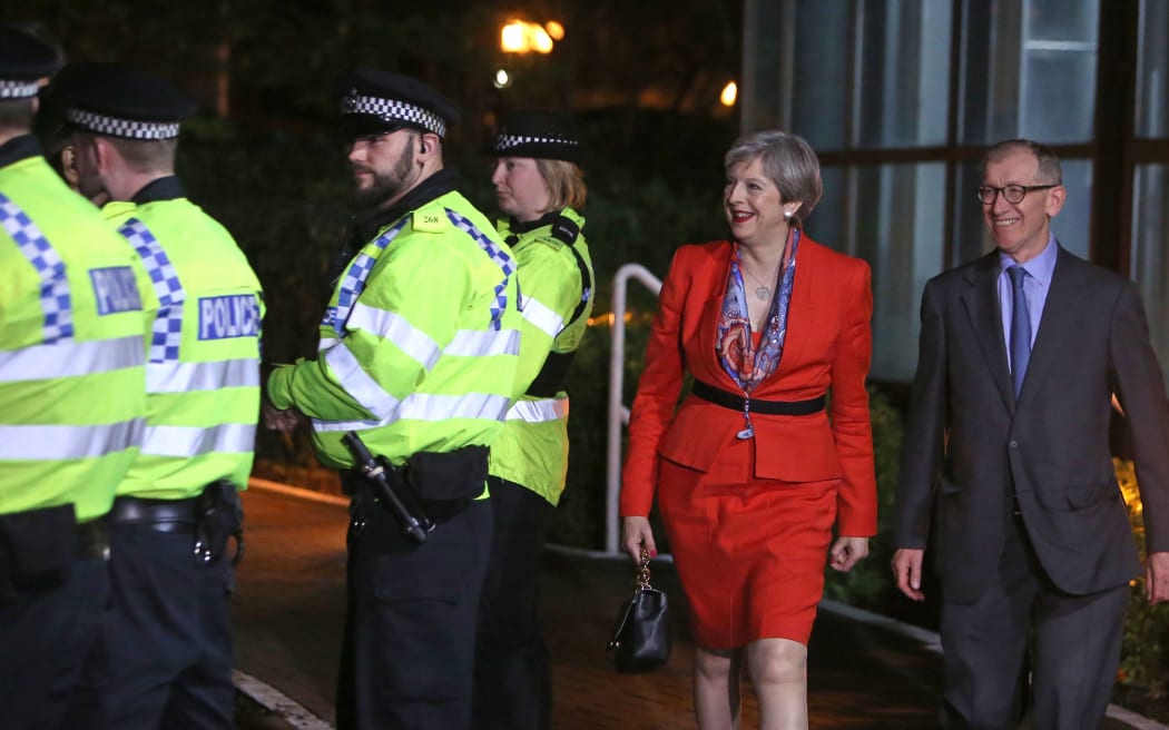 British Prime Minister Theresa May (2nd R) arrives with her husband Philip (R) at the count centre in Maidenhead early in the morning of June 9, 2017, hours after the polls closed in Britain's general election.