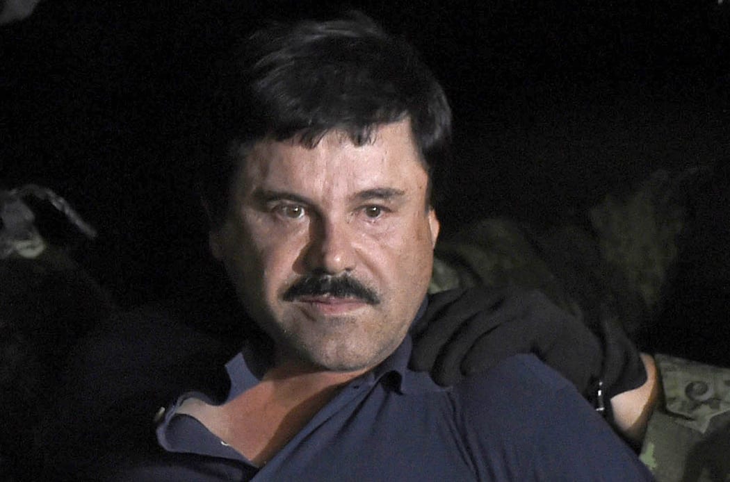 Drug kingpin Joaquin "El Chapo" Guzman is escorted into a helicopter at Mexico City's airport.