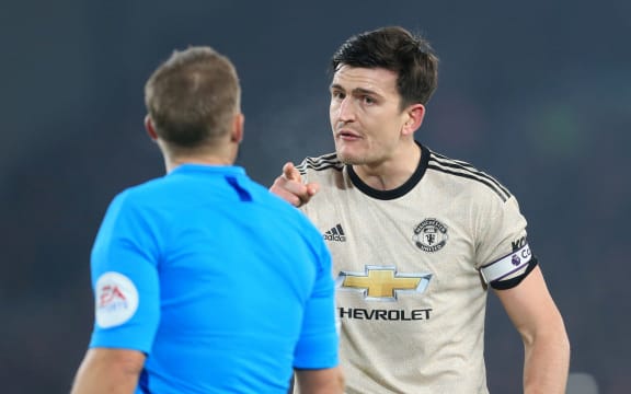 Manchester United captain Harry Maguire points an accusing finger at the referee.