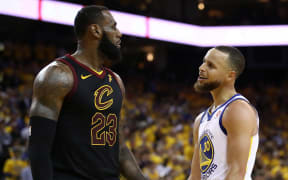 Stephen Curry #30 of the Golden State Warriors exchanges words with LeBron James #23 of the Cleveland Cavaliers in overtime during Game 1 of the 2018 NBA Finals.