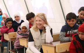 On 1 March 2023 in in Aleppo, Syria, UNICEF Executive Director Catherine Russell sits with children while visiting Ahmad Adeeb Al-Ali School (“The School Shelter”), which is currently operating as a temporary collective shelter for children and families affected by the recent devastating earthquakes.

The School Shelter accommodates 210 families, including three children with disabilities. UNICEF supports an integrated package of services, including non-formal inclusive education activities, child protection services for children and caregivers through Psychological First Aid sessions and structured recreational activities, as well as – specifically for youth – Life Skills in Emergency sessions and basic vocational handicrafts classes for girls. Interactive awareness sessions are offered by volunteers, on hygiene, how to act during emergencies, theatre and storytelling. And UNICEF has distributed winter clothing kits and blankets to people staying in the shelter.

Across Aleppo, UNICEF has installed 10...