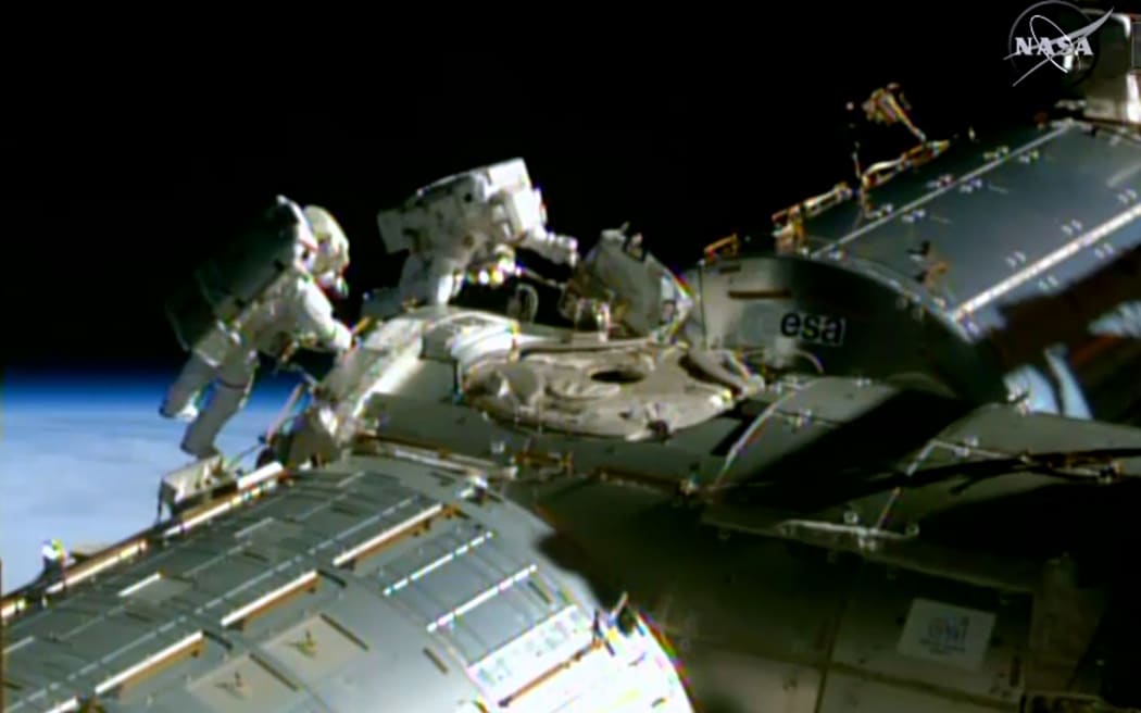 A NASA TV image shows NASA astronauts Barry Wilmore(L) and Terry Virts during a spacewalk to lay cable on the International Space Station.