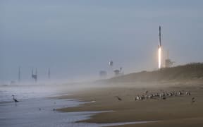 A SpaceX Falcon 9 rocket carrying 60 Starlink satellites forms a vapor cone after launching from pad 39A at the Kennedy Space Center in Florida in March.
