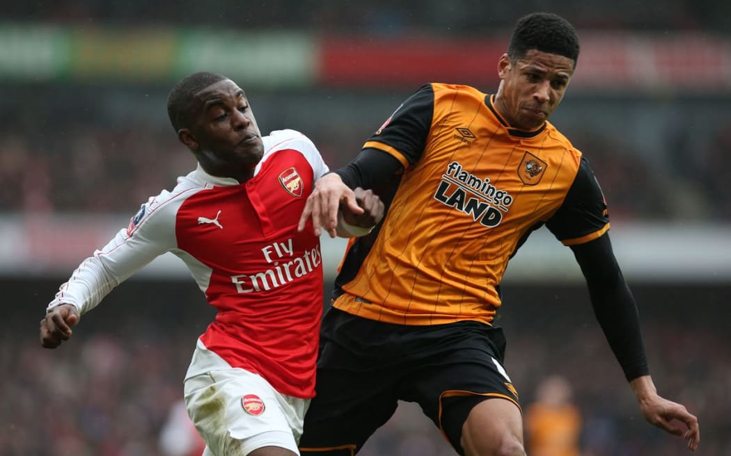 Joel Campbell of Arsenal and Curtis Davies of Hull City clash in the FA Cup - Photo: Charlotte Wilson / Offside