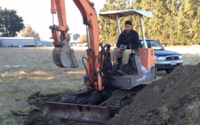 Josh Olykan burying the sheep that were attacked by dogs on his parents' property.