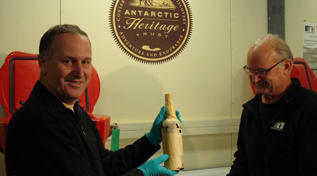 John Key handed the whisky to Antarctica NZ chairman Rob Fenwick at Scott Base.