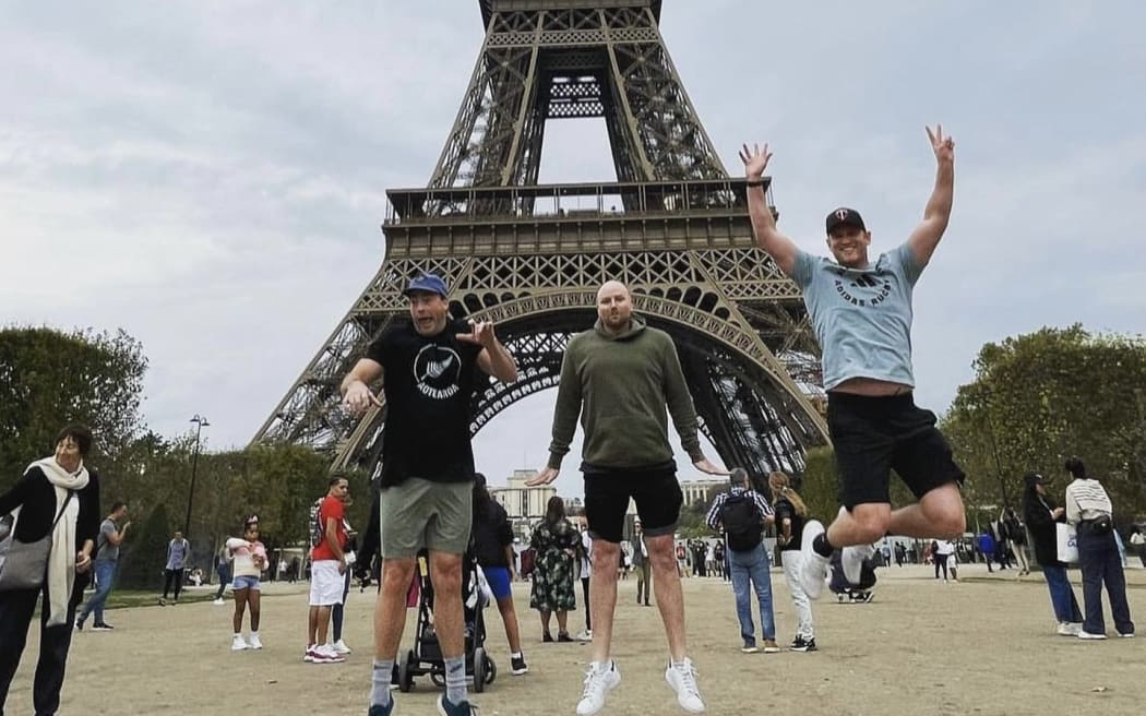 Andy Peat (right), Kim Boustridge and Adam John (left) at the Eiffel Tower during the France 2023 Rugby World Cup.