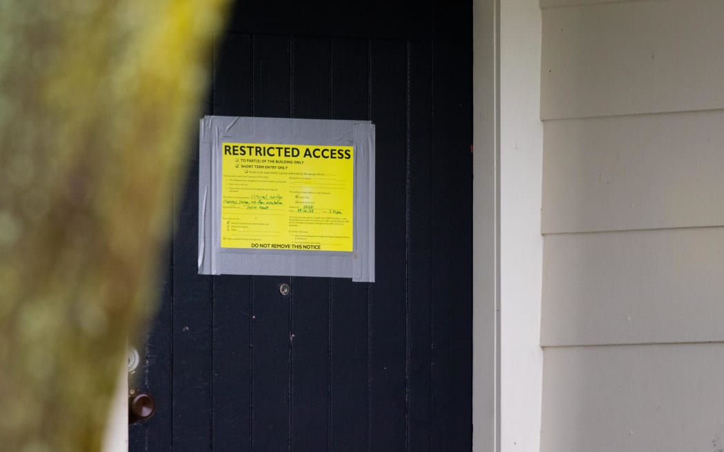 Yellow stickered house in Ranui, Auckland.