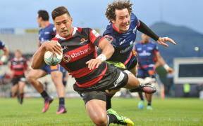 Richie Mo'unga dives for the try line with Marty Banks in tow.