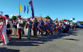 A procession of people dressed in medieval costumes