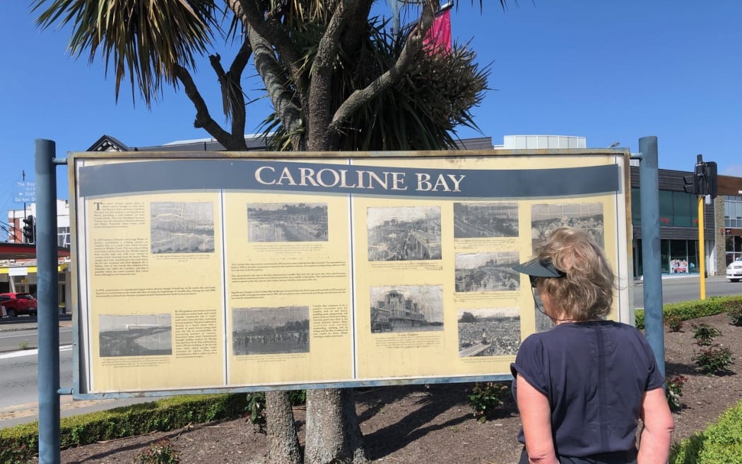 A sign outlining Caroline Bay's history on the main street of Timaru.
