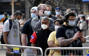 People wait in a queue for their Covid-19 coronavirus vaccination in Sydney.