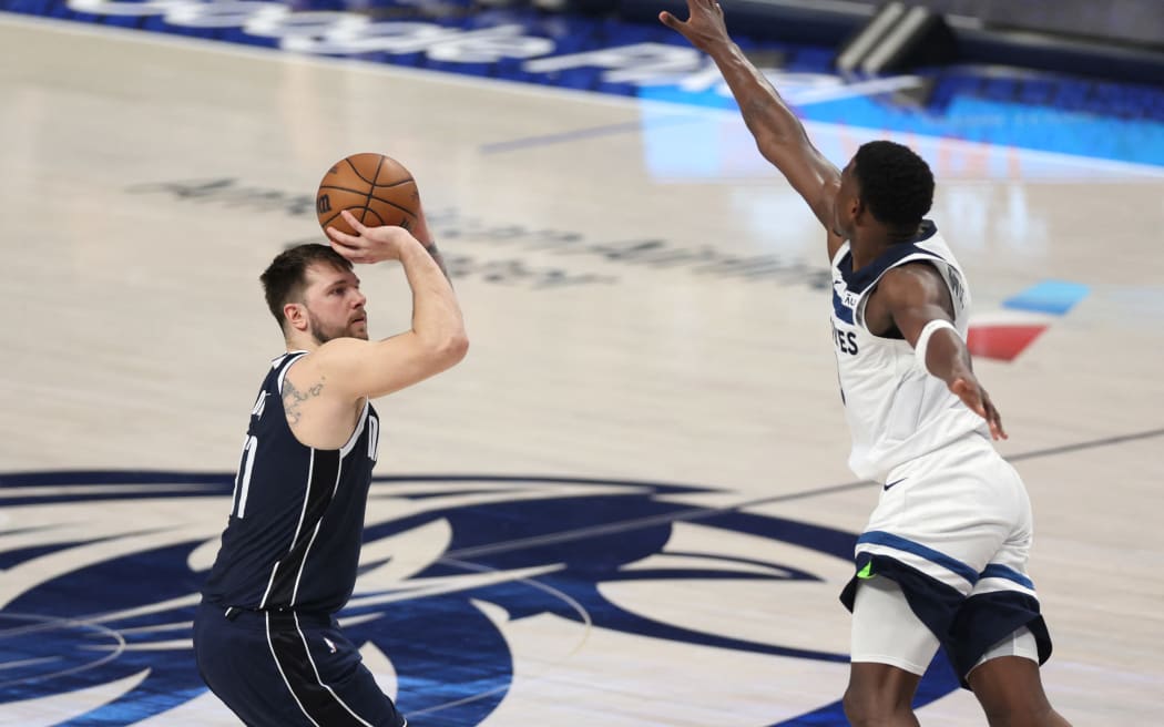 Luka Doncic of the Dallas Mavericks attempts a shot against Anthony Edwards in the second quarter of their NBA Western Conference play off match.