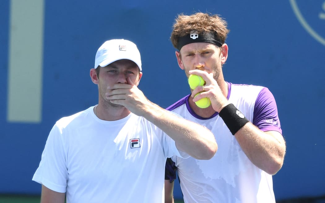 Michael Venus (right) of New Zealand talks with Neal Skupski of Great Britain during a doubles final match against Raven Klaasen of Brazil and Ben McLachlan of Japan on Day 9 during the Citi Open at Rock Creek Tennis Center on August 8, 2021 in Washington, DC.