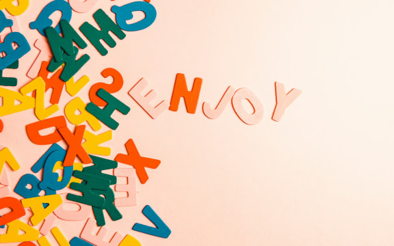 random colourful letters on a pink background